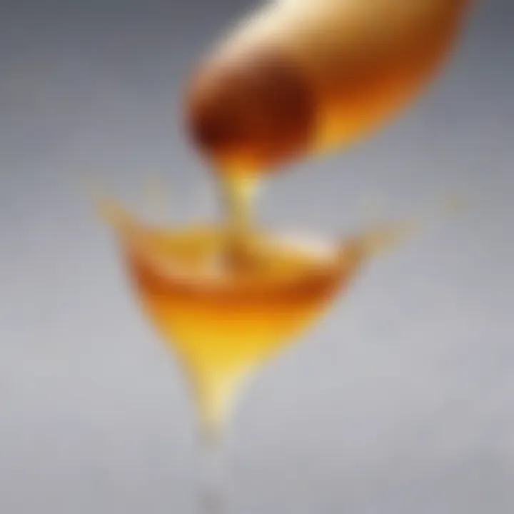 A close-up of a drop of honey slowly moving across a surface, showcasing high viscosity